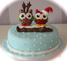 a cake decorated with two owls on top of it