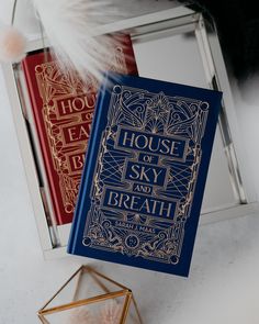 a blue book sitting on top of a white table next to a red and gold box