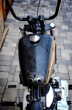 a motorcycle parked on the side of a brick road