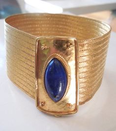 Made in Santorini, this beautiful bracelet is made of 22K yellow gold (stamped K22). It is 8" in length, including the clasp, and the gold grain embellished clasp has a 20mm x 9mm marquise shaped piece of lapis bezel set into its center.BRACELET WIDTH: 1.2 inchesWEIGHT: 59.4gThis bracelet is part of a set. The necklace is offered for sale separately: https://www.etsy.com/listing/287155675/greek-22k-yellow-gold-and-lapis-lazuli 22k Gold Bracelets For Formal Occasions, Luxury 22k Gold Bracelet For Formal Occasions, Elegant 22k Gold Bracelet For Formal Occasions, Luxury 22k Gold Formal Bracelet, Formal Yellow Gold Byzantine Bracelet, Formal Byzantine Yellow Gold Bracelets, Yellow Gold Byzantine Bracelet For Formal Occasions, Handmade Yellow Gold Bracelet For Formal Occasions, Formal Byzantine Yellow Gold Bracelet