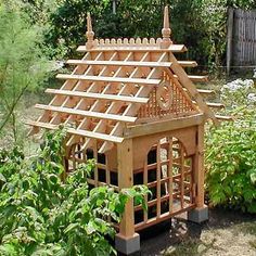 a small wooden house sitting in the middle of a garden