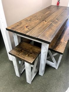 a wooden table with two benches underneath it