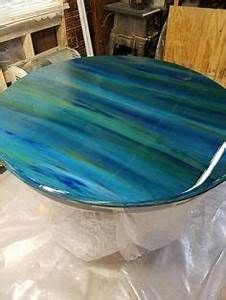 a blue and green table sitting on top of a plastic sheet in a room filled with furniture