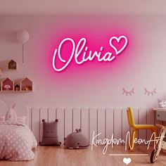 a pink neon sign that says,'julia'on the wall above a bed