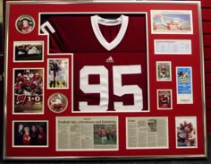 a football jersey is on display with photos and other memorabilia in the frame, as well as pictures