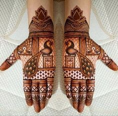 two hands with henna designs on them, one is decorated and the other is painted