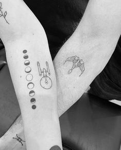 two people with matching tattoos on their arms