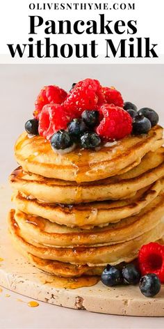 pancakes stacked on top of each other with blueberries and raspberries on top