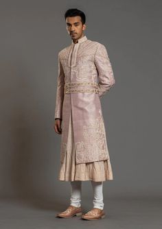 Baby Pink Hand Embroidered Wedding Sherwani
Designer custom made Baby Pink Hand fully embroidered sherwani with chudidar in UK . The latest heavy silk embroidered sherwani is best choice for groom . It is suited for Indian and Pakistani wedding wear . 
One of the standout features of this sherwani is the intricate embroidery adorning its surface. Our skilled artisans have meticulously handcrafted every detail, using fine threads and intricate patterns that showcase traditional Indian craftsmanship at its best. The embroidery showcases a harmonious blend of motifs, ranging from floral designs to intricate geometric patterns, creating a visually stunning ensemble that captures attention and admiration . Please note there can be slightly difference between the image and the product due to s Sherwani Design, Sufi Night, Mens Designer Shirts, Embroidered Wedding, Fashion Suits