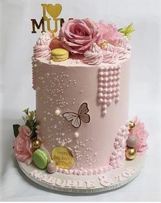 a pink cake decorated with flowers and butterflies