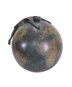 a large metal ball with a small figure on top