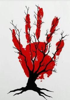 a red hand print on white paper with tree branches and bare branches in the foreground