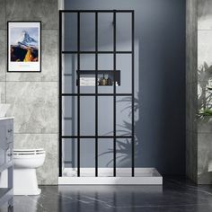 a bathroom with a toilet, sink and shower stall in the middle of the room