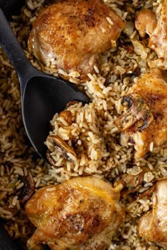 chicken and rice in a skillet with two spoons