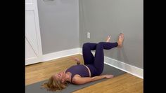 a woman is doing an exercise on a yoga mat