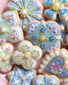 some decorated cookies are on a pink plate