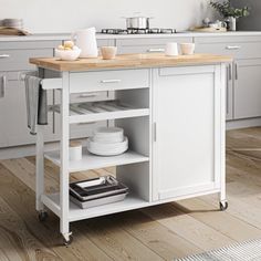 a kitchen cart with two bowls and plates on it, sitting in front of a wall