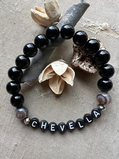 Customized name/ word bracelet. Black onyx beads with black with white letter beads. Name Jimmy Bracelet, Paris Jackson Bracelets, Word Bracelet, Letter Beads, Onyx Bead, Name Bracelet, Bracelet Black, White Letters, Black Onyx