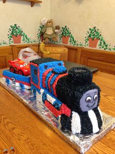 a birthday cake made to look like a thomas the tank engine train on a table