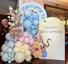 winnie the pooh birthday party with balloons and welcome sign for guests to come home