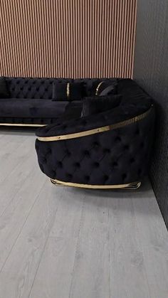 two black couches sitting next to each other in a room