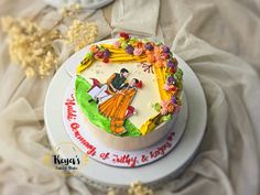 there is a cake that has been decorated with people and flowers on the top layer