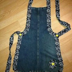 an apron made out of denim with flowers on it