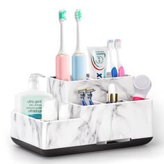 a white marble desk organizer with toothbrushes and other items