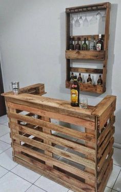 a bar made out of wooden pallets with bottles on top