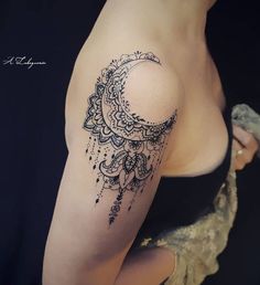 a woman's arm with a tattoo on it that has a crescent moon and stars