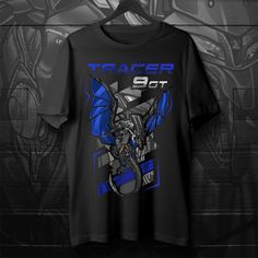 T-Shirts for Yamaha Tracer 9 Motorcycle Riders Do you ride a motorcycle? Check out our t-shirts inspired by the Yamaha Tracer 9     This high-quality shirt is designed to be the perfect combination of style and comfort during your motorcycle journeys.  Inspired by the iconic Yamaha Tracer 9 design, this tee shirt serves as the ultimate homage to these legendary motorcycles that have stolen the hearts of riders worldwide. You can also find hoodies with these same designs in our shop.  This classic unisex short sleeve biker shirt offers ample room for your motorcycle riding movements. The soft cotton and quality print will make you fall in love with it over and over again. It comes with ribbed knit collars for enhanced shaping. Shoulder taping ensures a better fit over time, and dual side se Sublimation Print Short Sleeve T-shirt For Motorcycling, Black Biker Fan Merchandise T-shirt, Black Biker T-shirt For Fan Merchandise, Black Graphic Print Shirt For Biker Events, Black Graphic Shirt For Biker Events, Black Graphic T-shirt For Motorcycling, Black Graphic Print T-shirt For Motorcycling, Graphic Print Biker Shirt For Biker Events, Biker Style Shirt With Graphic Print For Biker Events