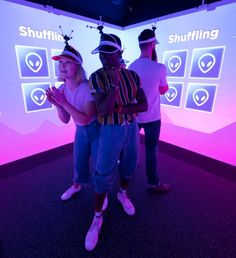 two people standing in front of a screen with the word shuffler on it,