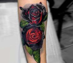 a black and red rose tattoo on the right arm with green leaves around its petals