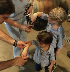 a group of people standing around each other holding wine glasses