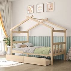 a child's bed with a wooden frame and canopy over it in a room