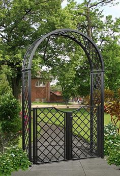 a black metal gate in the middle of a park