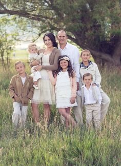 a family posing for a photo in the grass