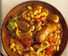 a wooden bowl filled with pasta and beans