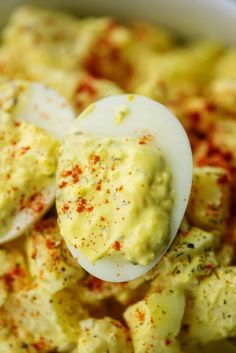 deviled egg potato salad in a white bowl with text overlay that reads deviled egg potato salad