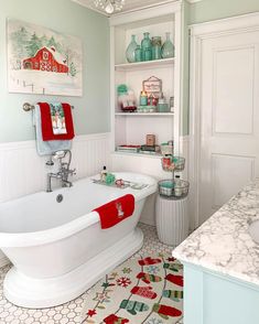 a white bath tub sitting in a bathroom next to a sink and counter top under a chandelier