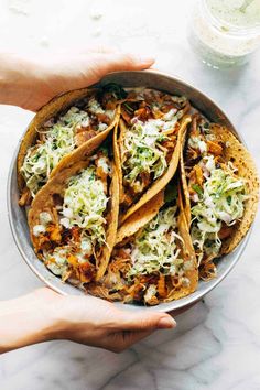 a bowl filled with tacos and shredded cheese