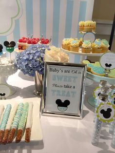 a table topped with lots of desserts and cupcakes