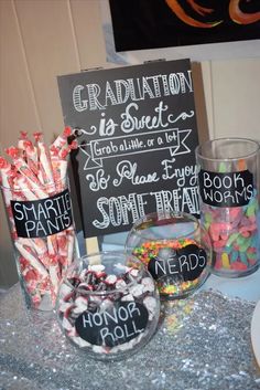 a table with candy and graduation signs on it