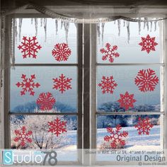 snowflakes are hanging from the window sill in front of an icy landscape