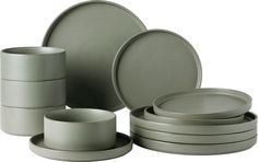 a set of grey dishes and cups on a white background