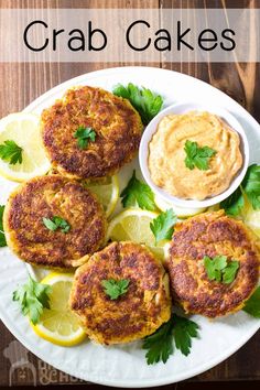 crab cakes on a plate with lemons and parsley