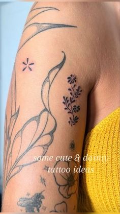 the back of a woman's arm with tattoos on it