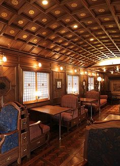 the interior of an old fashioned wooden cabin with wood paneling and carved ceiling beams