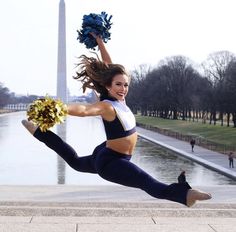 a cheerleader is jumping in the air with her pom - poms on