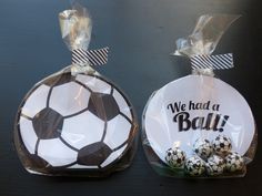 two soccer balls wrapped in cellophane and tied with ribbon